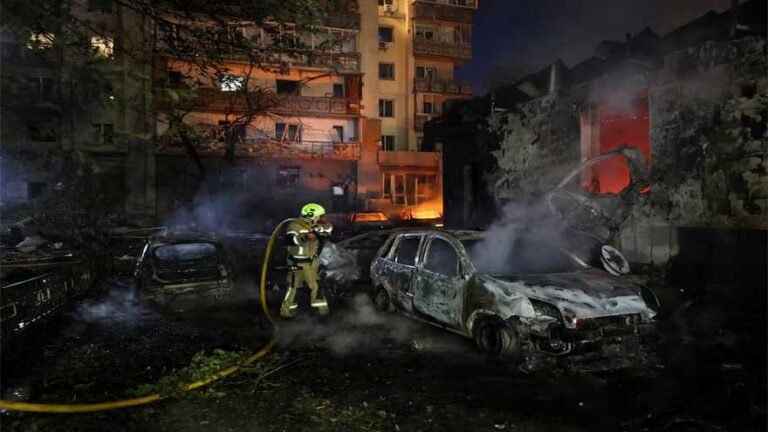 Emergency responders at the scene of Russian missile strikes in Kyiv following overnight attacks.