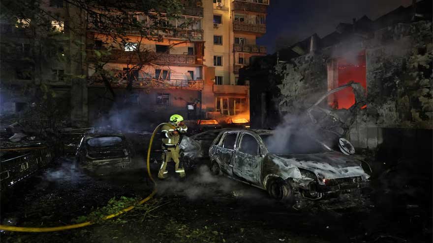 Emergency responders at the scene of Russian missile strikes in Kyiv following overnight attacks.