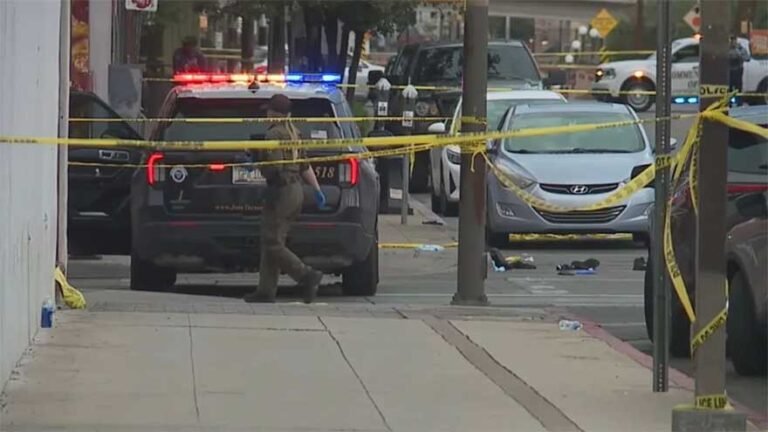 Police officers investigate the scene of a mass shooting in Tucson, Arizona, where 10 people were injured.