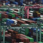 Chinese and European Union flags displayed as China imposes export controls on European firms in response to EU sanctions.