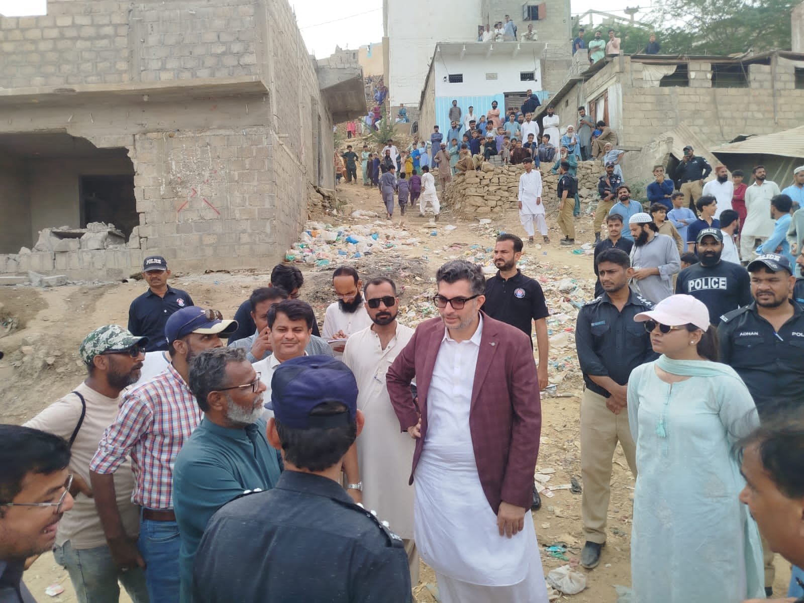 Officials oversee the Karachi Water and Sewerage Corporation's anti-encroachment operation at Qasba Reservoir in North Nazimabad.
